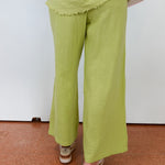 Person wearing green pants on a white background