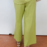 Person wearing green pants on a white background