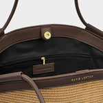 Brown handbag with visible brand name on a light gray background