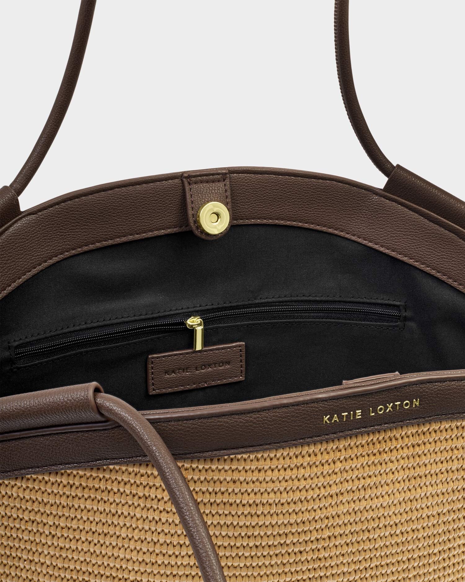 Brown handbag with visible brand name on a light gray background