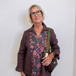 Woman wearing a patterned blouse with a plain background