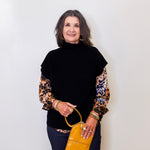 Woman holding a yellow handbag against a white background