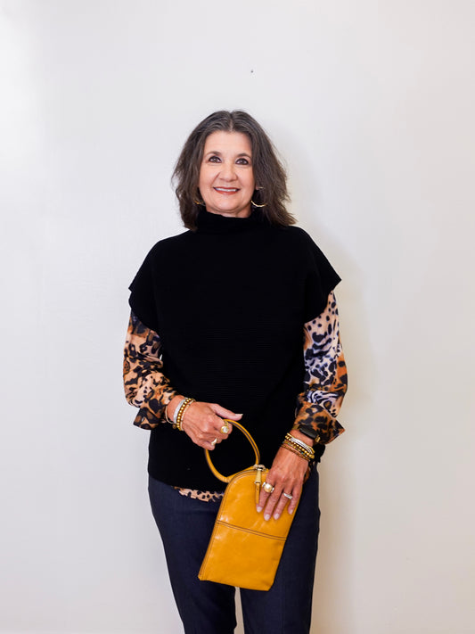 Woman holding a yellow handbag against a white background