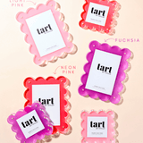 Set of pink and fuchsia 'tart' products on a beige background