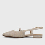 Beige sandal with a crocodile pattern on a light gray background
