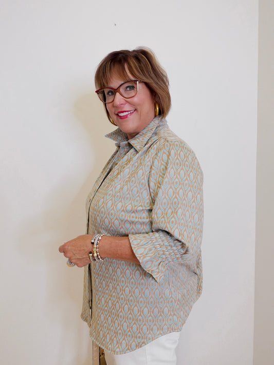 Woman wearing a patterned shirt against a plain background