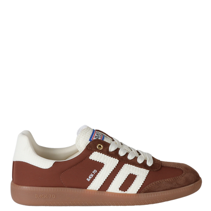 Brown and white sneaker with visible branding on a white background