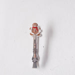 Gingerbread man-themed spoon on a white background