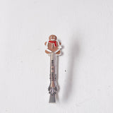 Gingerbread man-themed spoon on a white background