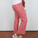Person wearing red and white checkered pants with a plain background