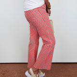 Person wearing red and white checkered pants with a plain background
