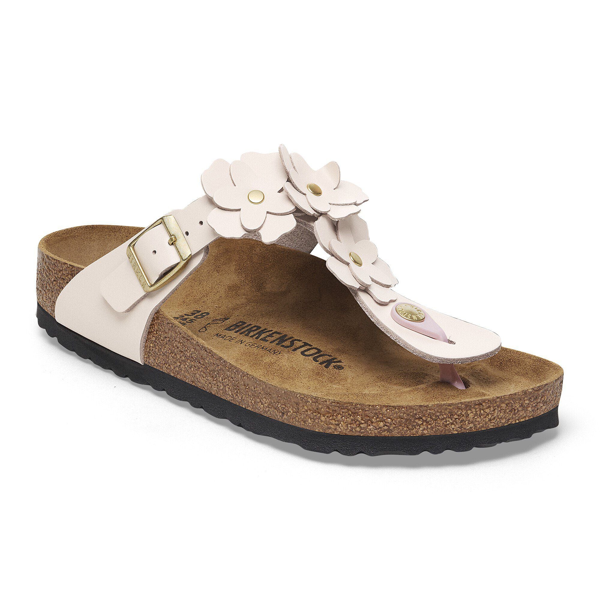 White sandal with floral design and cork sole on a white background