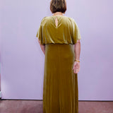 Gold velvet flutter sleeve maxi dress with a flattering waistline and slit hem, offering a chic and timeless evening style.