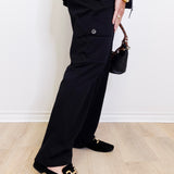 woman wearing a black habitat pant against a white background. 