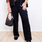 woman wearing a black French Terry easy pocket pant in black against a white background. 