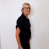 Person wearing a black outfit against a white background