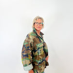 Person wearing a camouflage jacket on a white background