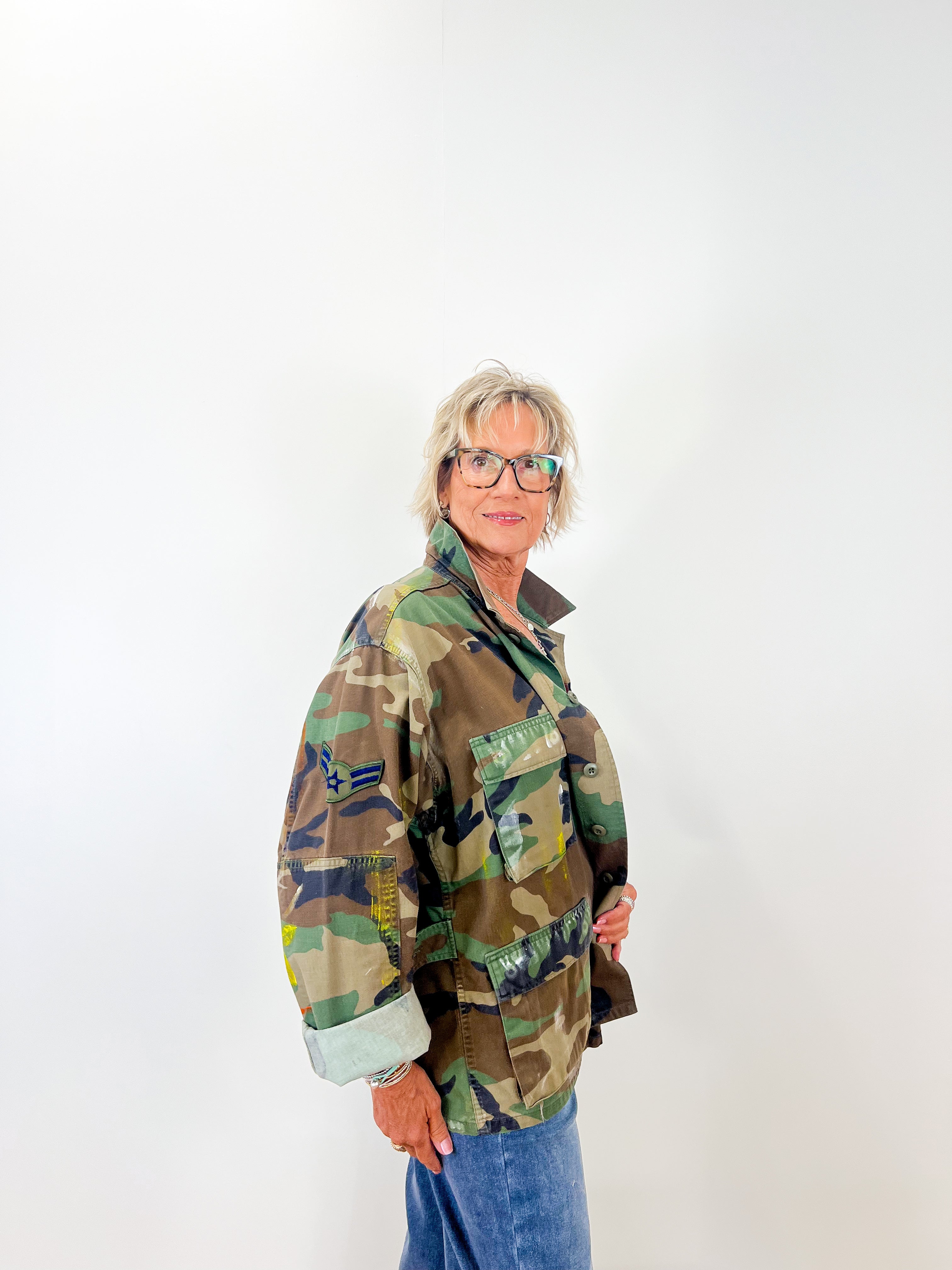 Person wearing a camouflage jacket on a white background