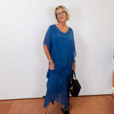 model wearing the helen silk kaftan long dress in blue with a flowy silhouette