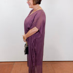 model wearing the helen silk kaftan long dress in eggplant with a flowy silhouette