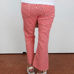 Red and white checkered pants worn by a person on a plain background