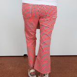 Red and white checkered pants worn by a person on a plain background