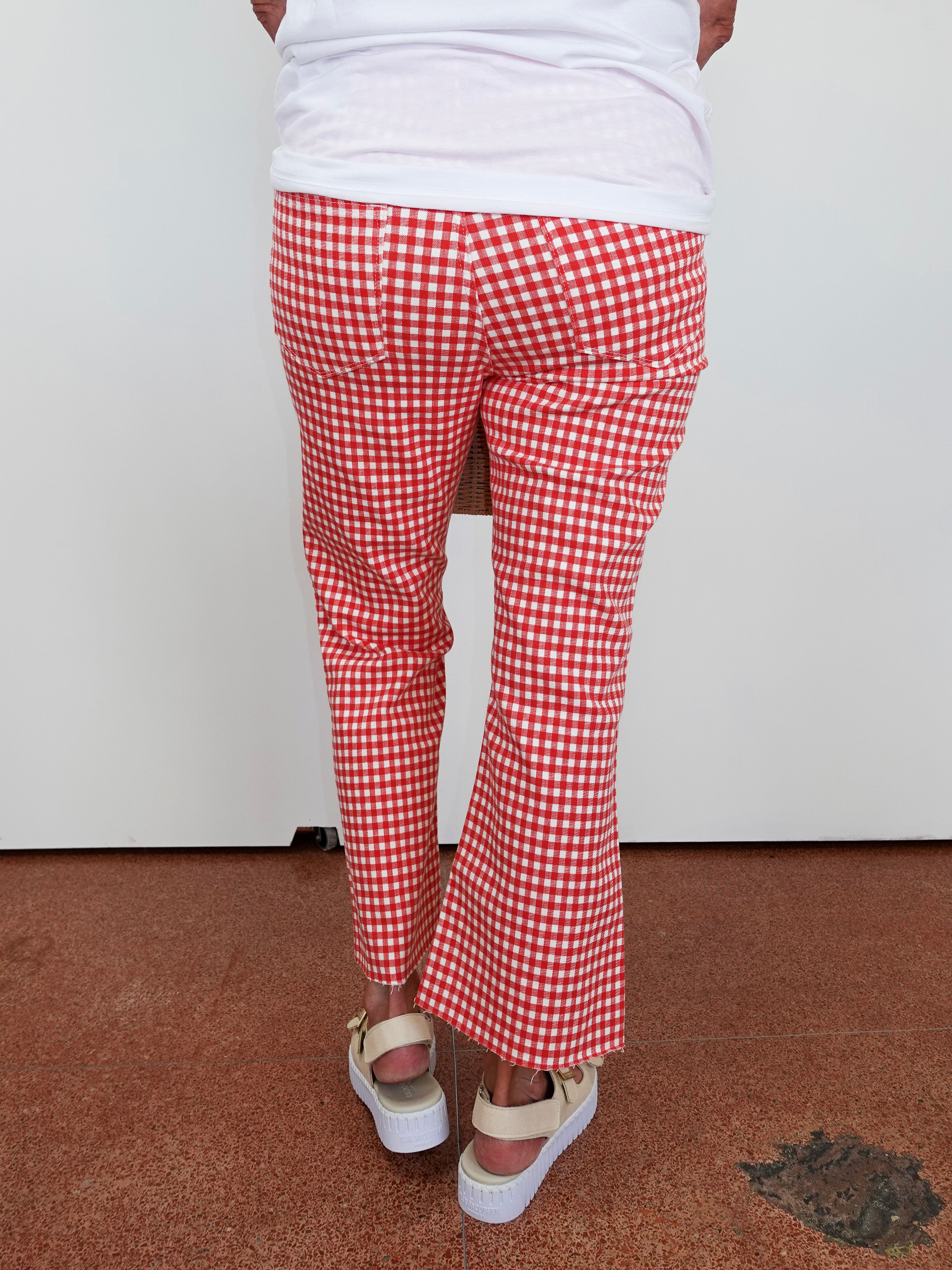 Red and white checkered pants worn by a person on a plain background