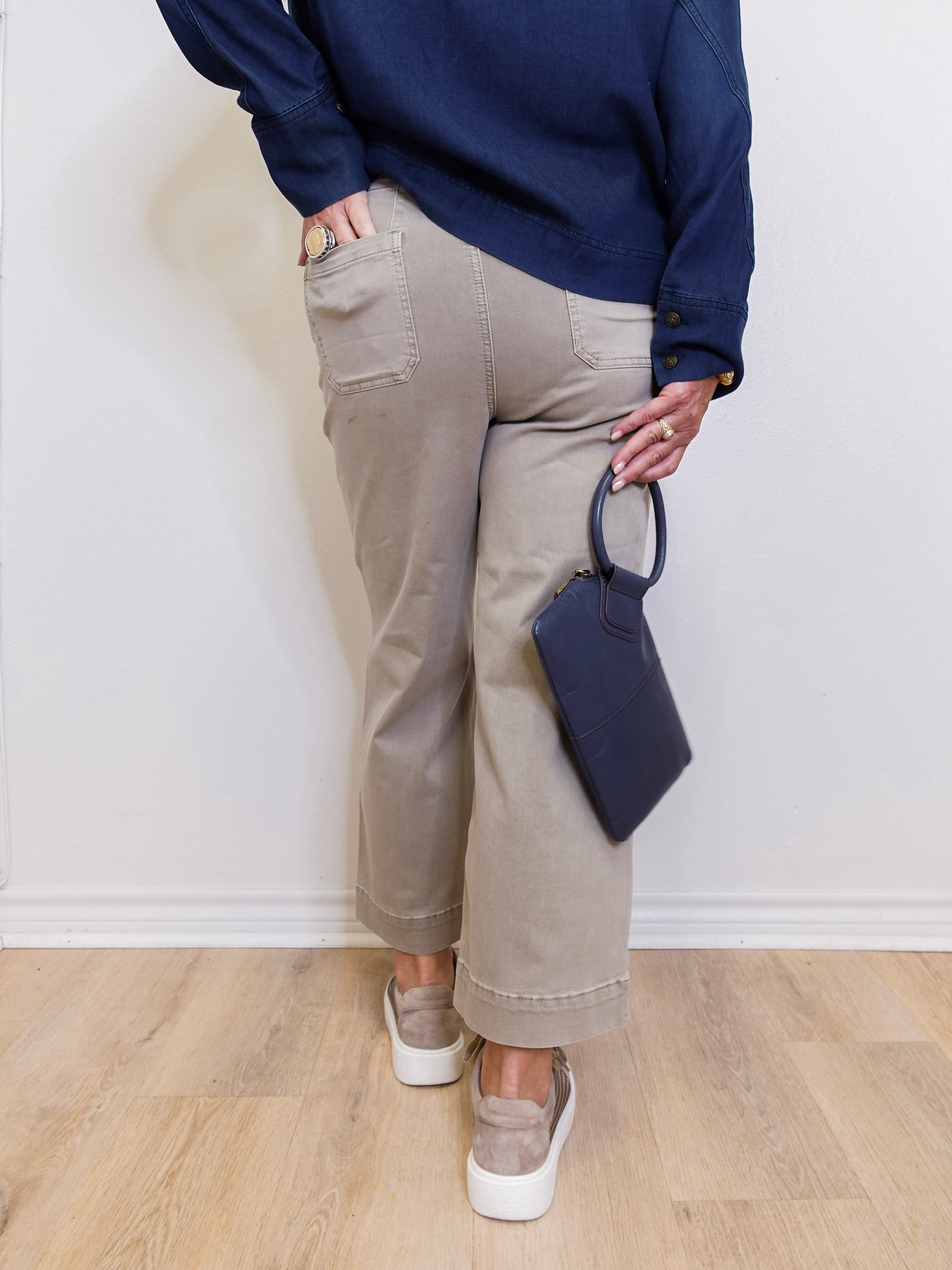 Women’s cropped wide leg pants featuring patch pocket detail in front. a white background. 