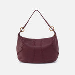 Maroon handbag with gold accents on a white background