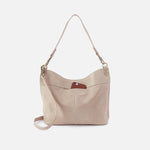 Beige handbag with a brown patch on a white background