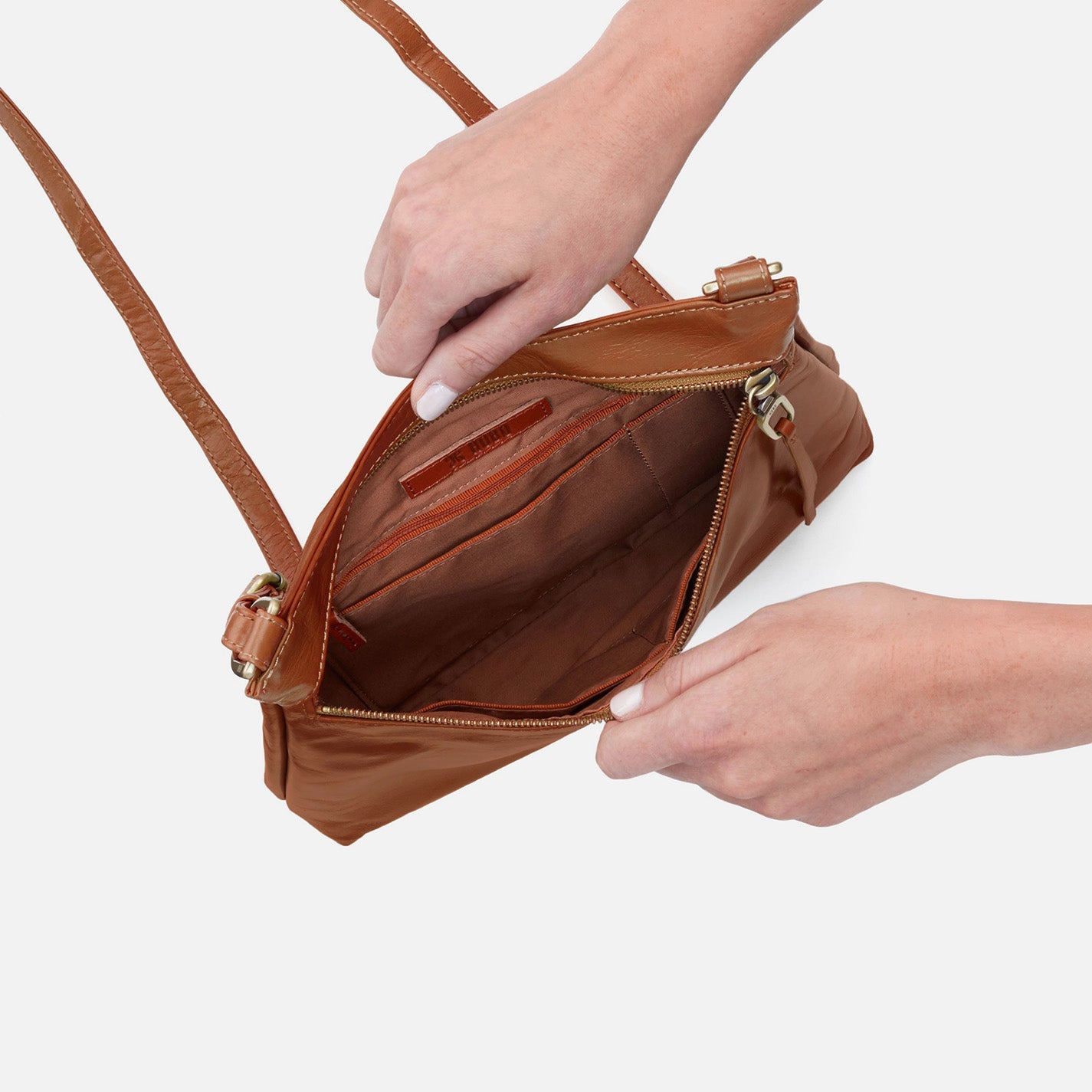 Hobo Cambel Crossbody bag in truffle leather featuring sleek silhouette and practical design.