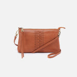 Brown leather crossbody bag with decorative stitching on a white background