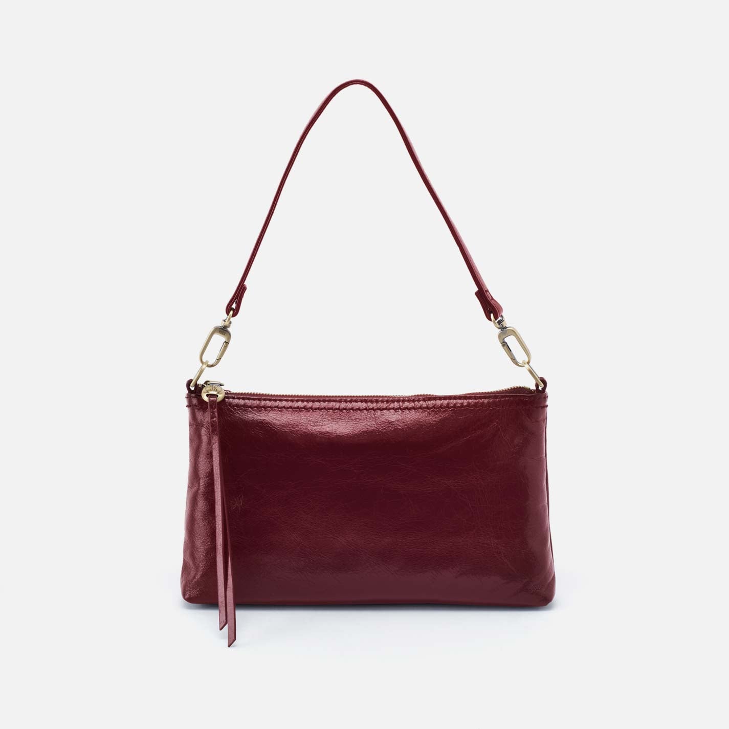 Maroon handbag with a strap on a light gray background