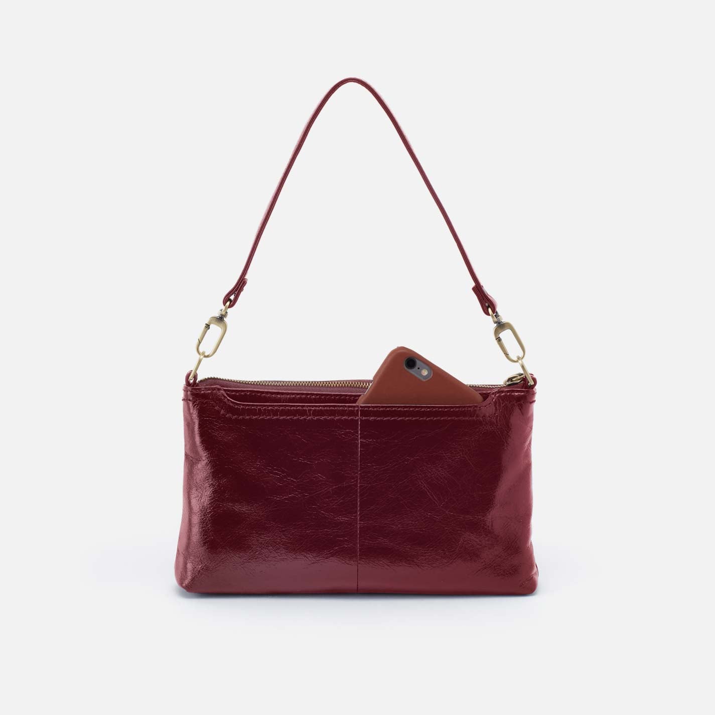Red leather handbag with a brown patch on a white background