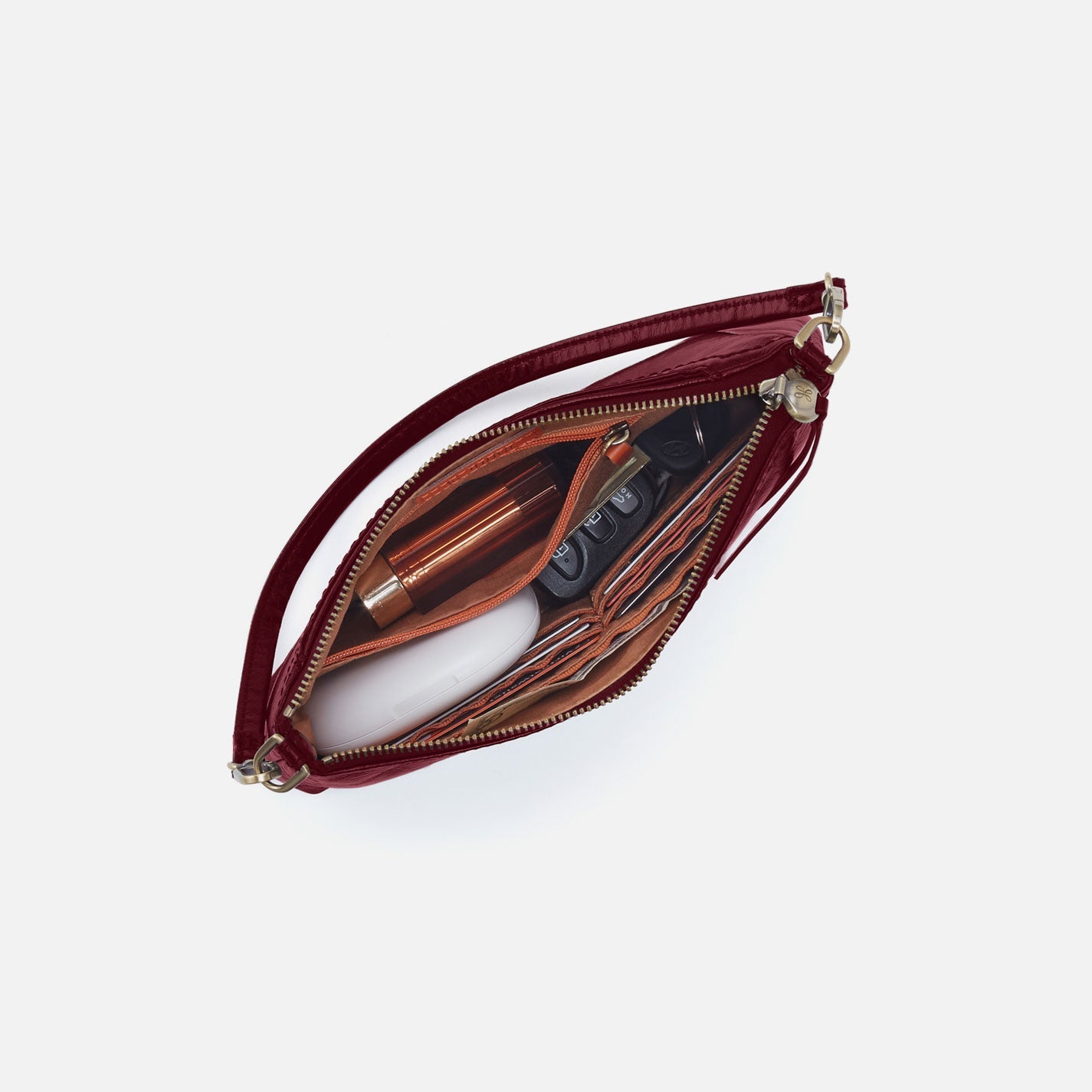 Open red handbag with gold zipper on a white background