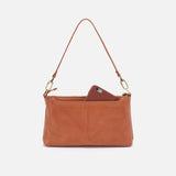 Brown leather handbag with a phone inside on a white background