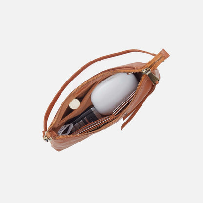 Brown leather pouch with a white object inside on a light gray background