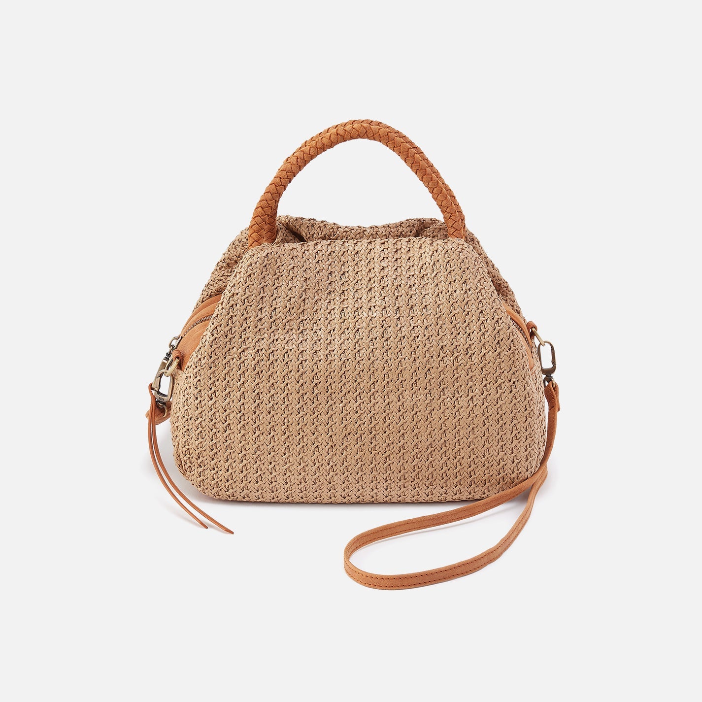 Woven handbag with brown handle and strap on a white background