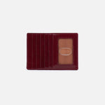 Red leather cardholder with a clear plastic window on a white background