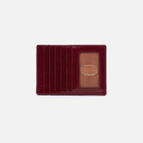 Red leather cardholder with a clear plastic window on a white background