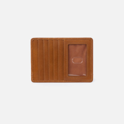 Brown leather wallet on a light gray background