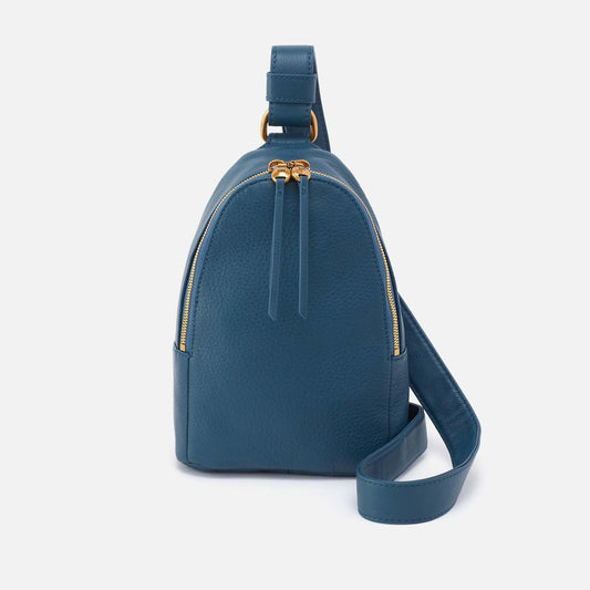 Blue backpack with gold zippers on a white background