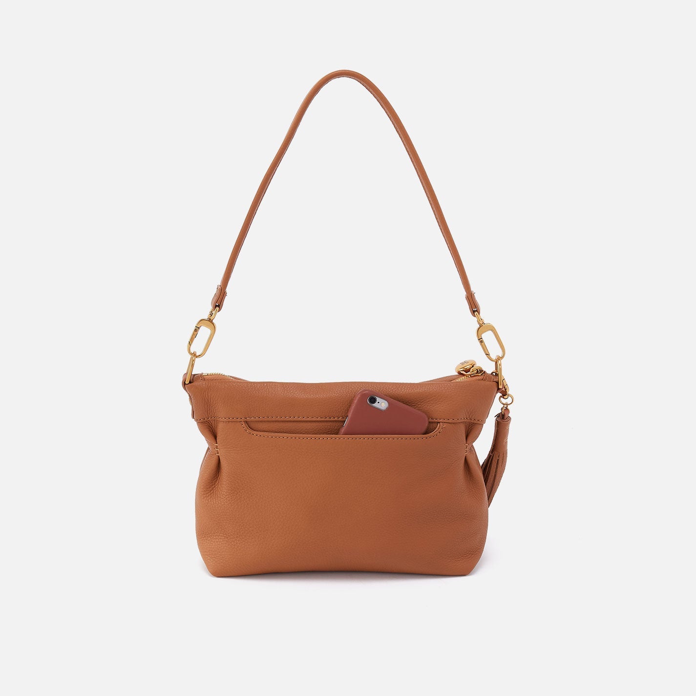 Hobo Kori Crossbody in warm honey leather with adjustable strap and zip closure