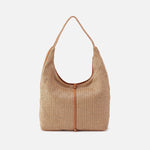 Woven handbag with leather accents on a white background