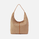 Woven handbag with leather accents on a white background