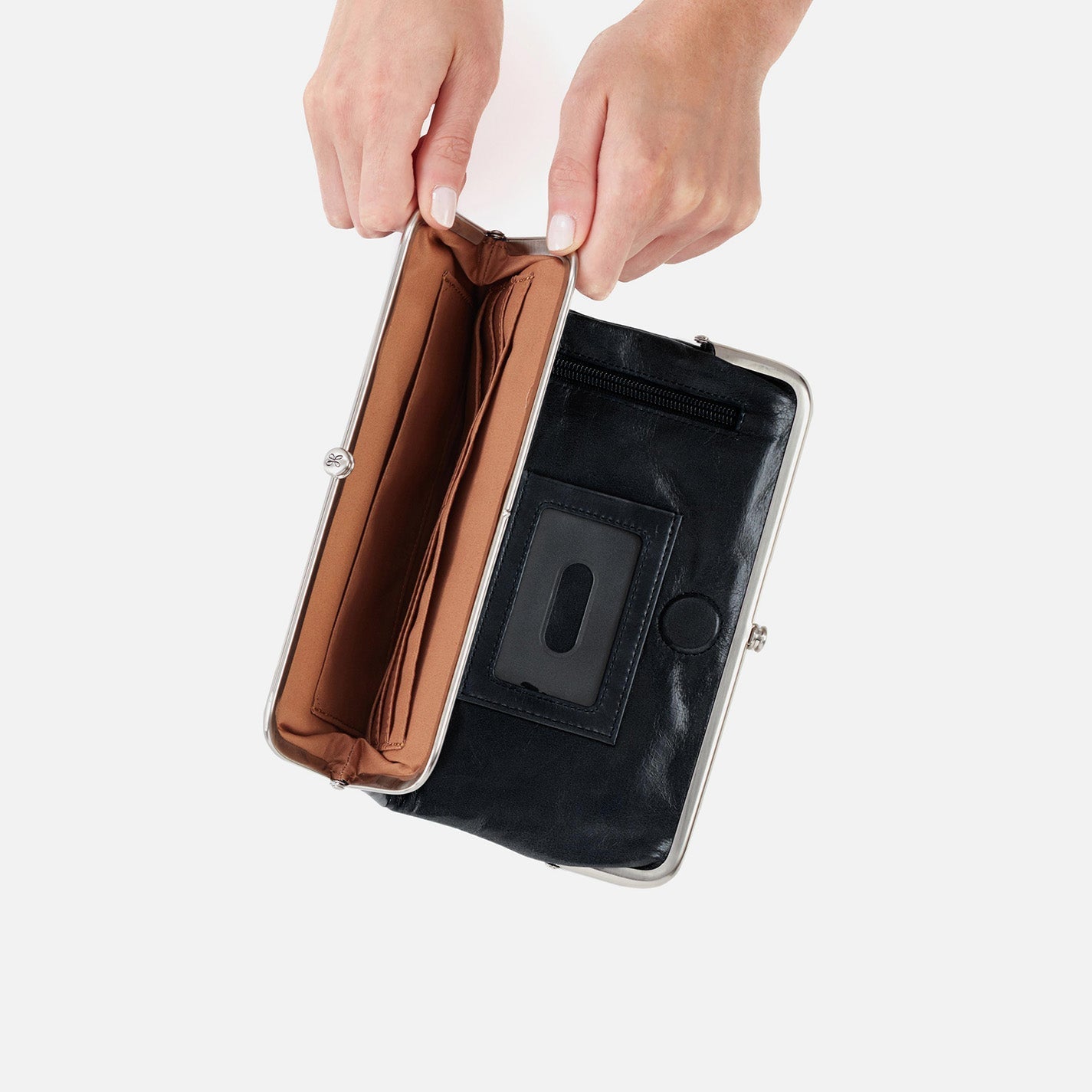 Black clutch with a metallic interior held by a hand on a white background