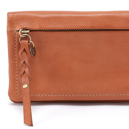 Brown leather wallet with braided strap on a white background