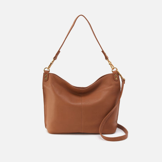 Brown leather handbag with a shoulder strap on a white background