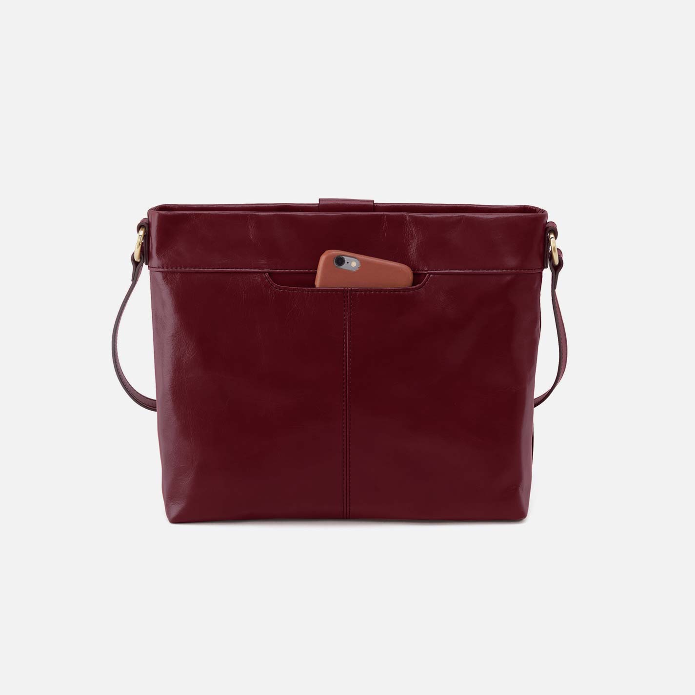 Maroon leather handbag with a brown pocket on a light gray background
