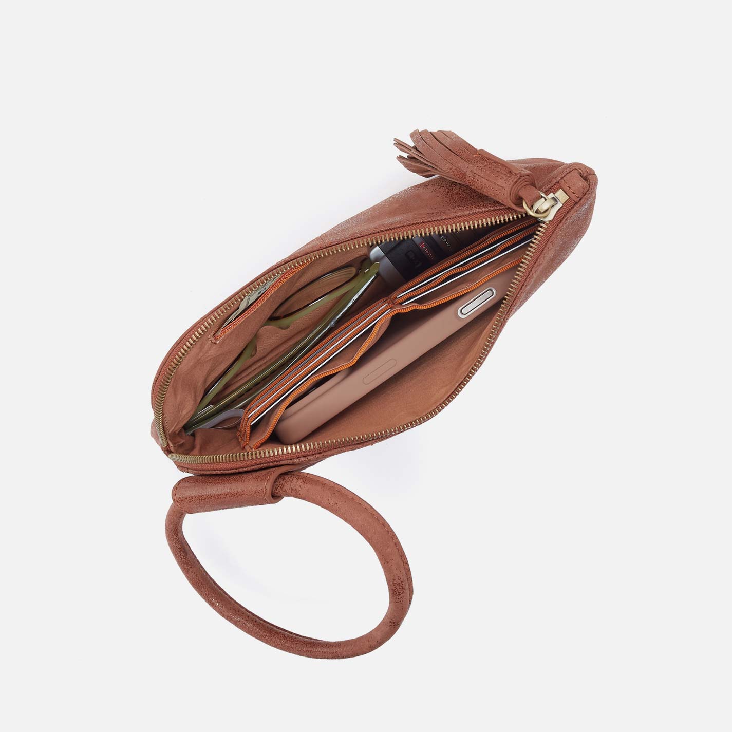 Brown leather clutch with a tassel on a white background